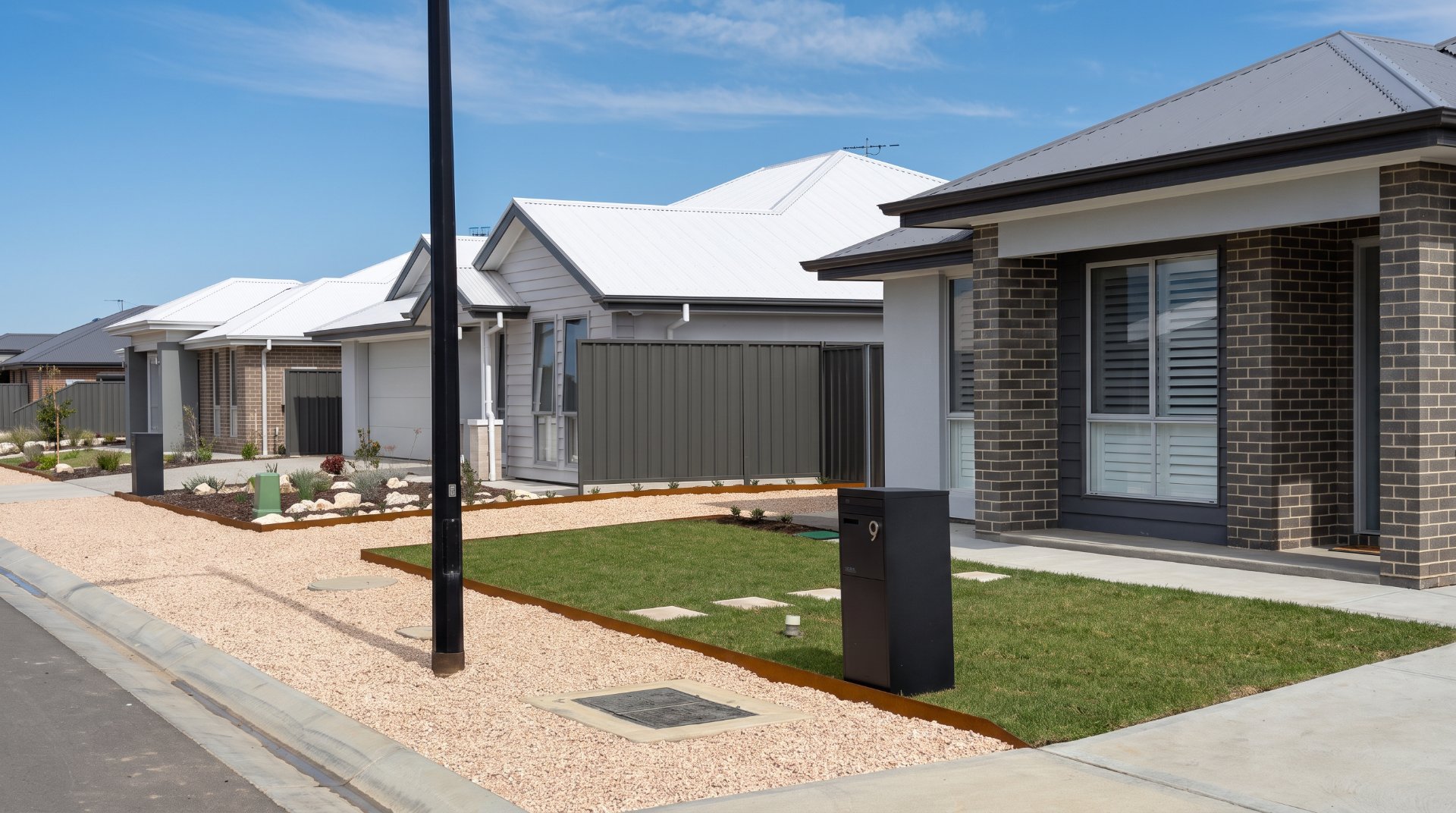 Front yard with fresh turf, stepping pavers, gravel and corten steel edging